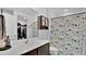 Modern bathroom with white countertop, brown cabinets, and a decorative shower curtain at 3081 Cloverdale St, Deltona, FL 32738