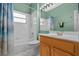 Clean bathroom with shower/tub combo, wood vanity, and large mirror at 3528 Chapel Hill Blvd, Clermont, FL 34711