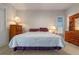 Cozy bedroom with a king-size bed and two wooden dressers at 3528 Chapel Hill Blvd, Clermont, FL 34711