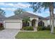 One-story house with a two-car garage and a manicured lawn at 3528 Chapel Hill Blvd, Clermont, FL 34711