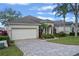 One story house with light beige walls, and a paved driveway at 3528 Chapel Hill Blvd, Clermont, FL 34711