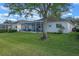 Back of house with screened patio and grassy yard at 3528 Chapel Hill Blvd, Clermont, FL 34711