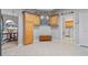 Kitchen with wood cabinets, tile floors, and laundry room access at 3528 Chapel Hill Blvd, Clermont, FL 34711
