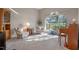 Bright sitting room with two armchairs and a piano near a large window at 3528 Chapel Hill Blvd, Clermont, FL 34711