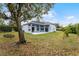 Spacious backyard with large tree and swing set at 5001 Whitewater Way, Saint Cloud, FL 34771