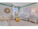 Charming Bedroom with a crib, changing table, armchair, and playful decor at 5111 Tana Ter, Saint Cloud, FL 34772