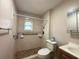 Updated bathroom with shower, grab bars, and toilet at 5165 Gwynne Ave, Orlando, FL 32810