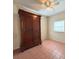 Bedroom with tile floors and large wooden wardrobe at 5165 Gwynne Ave, Orlando, FL 32810