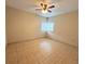 Spacious bedroom with tile floor and ceiling fan at 5165 Gwynne Ave, Orlando, FL 32810