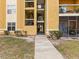 Exterior view of a yellow building with stairs and walkway at 5255 Images Cir # 306, Kissimmee, FL 34746