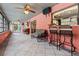 Florida room with tile floor, couch, bar stools, and ceiling fans at 6433 Wynglow Ln, Orlando, FL 32818