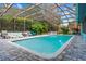 Inviting pool with a screened enclosure and surrounding patio at 6433 Wynglow Ln, Orlando, FL 32818