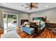 Main bedroom with hardwood floors, a ceiling fan, and direct access to the backyard at 660 Ferne Dr, Longwood, FL 32779