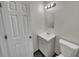 Clean and simple bathroom with white vanity, toilet, and tiled floor at 7008 Watseka Ave, Orlando, FL 32818