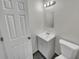 Clean, bright bathroom featuring a white vanity, toilet, and tiled floor at 7008 Watseka Ave, Orlando, FL 32818
