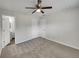 Bright bedroom with carpet flooring, double doors to closet, and ensuite bathroom at 7008 Watseka Ave, Orlando, FL 32818