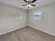 Empty bedroom with neutral gray walls, plush carpeting, and a ceiling fan at 7008 Watseka Ave, Orlando, FL 32818