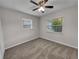 Empty bedroom with neutral gray walls, plush carpeting, and a ceiling fan at 7008 Watseka Ave, Orlando, FL 32818