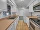 Well-appointed kitchen featuring white cabinetry and stainless steel appliances at 7008 Watseka Ave, Orlando, FL 32818