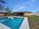 In-ground pool and patio with lush landscaping and trees at 7008 Watseka Ave, Orlando, FL 32818