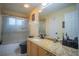 Bathroom with granite countertop, tub shower combo and updated fixtures at 8100 Fan Palm Way, Kissimmee, FL 34747