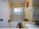 Bathroom with granite countertop, tub shower combo and updated fixtures at 8100 Fan Palm Way, Kissimmee, FL 34747