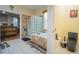 Bathroom with soaking tub, glass block shower, and separate toilet at 8100 Fan Palm Way, Kissimmee, FL 34747