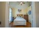 Bright bedroom with wood floors and a comfortable bed at 8100 Fan Palm Way, Kissimmee, FL 34747