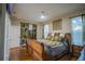 Main bedroom with king-size bed and hardwood floors at 8100 Fan Palm Way, Kissimmee, FL 34747
