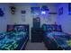 Twin beds in a themed bedroom with gaming decor at 8100 Fan Palm Way, Kissimmee, FL 34747
