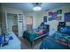 A bedroom with two twin beds, gaming-themed decor, and ample closet space at 8100 Fan Palm Way, Kissimmee, FL 34747