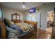 Main bedroom with king-size sleigh bed, en-suite bathroom access at 8100 Fan Palm Way, Kissimmee, FL 34747