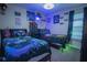 Bedroom with two twin beds, gaming-themed decor, and ample closet space at 8100 Fan Palm Way, Kissimmee, FL 34747