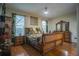 Main bedroom with large sleigh bed and hardwood floors at 8100 Fan Palm Way, Kissimmee, FL 34747