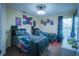 A bedroom with two twin beds, gaming-themed decor, and ample closet space at 8100 Fan Palm Way, Kissimmee, FL 34747