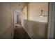 A long hallway with neutral walls and carpeted floors at 8100 Fan Palm Way, Kissimmee, FL 34747