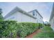 Side view of the house with green hedge at 8100 Fan Palm Way, Kissimmee, FL 34747