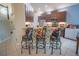 Breakfast bar with three stools in a modern kitchen at 8100 Fan Palm Way, Kissimmee, FL 34747