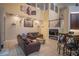 Two-story living room with leather sofas and high ceilings at 8100 Fan Palm Way, Kissimmee, FL 34747