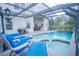 Relaxing pool area with lounge chairs and a covered patio at 8100 Fan Palm Way, Kissimmee, FL 34747