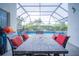 Covered patio with table and chairs, perfect for poolside relaxation at 8100 Fan Palm Way, Kissimmee, FL 34747