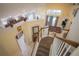 View of a bright and spacious two-story home's stairwell, showcasing an open floor plan at 8100 Fan Palm Way, Kissimmee, FL 34747
