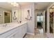 Modern bathroom featuring dual vanities, white cabinetry, and artwork at 9401 La Salle St, Groveland, FL 34736