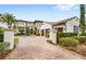 Impressive two-story home with a three-car garage and brick paver driveway at 10200 Carthay Dr, Golden Oak, FL 32836