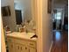 Bathroom vanity with a sink, mirror, toiletries, and a view to another room at 10470 Sw 99Th Ct, Ocala, FL 34481