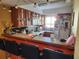 Kitchen features wood cabinets, a breakfast bar with seating, and appliances at 108 Scottsdale Sq # 108, Winter Park, FL 32792
