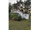 Quaint one-story house with mature trees and a grassy yard at 1406 Winn Ave, Orlando, FL 32806