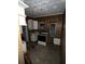 Small kitchen with wood paneling and older appliances at 1406 Winn Ave, Orlando, FL 32806