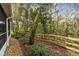 Private backyard space with mature trees and a wooden fence at 1455 Creekside Cir, Winter Springs, FL 32708