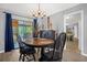 Quaint dining room with wooden table and chairs, and view to kitchen at 1608 Bomi Cir, Winter Park, FL 32792